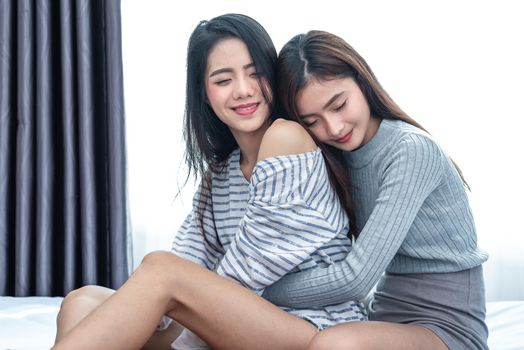 Two Asian Lesbian women hug and embracing together in bedroom. Couple people and Beauty concept. Happy lifestyles and home sweet home theme. Homosexual life theme. Love scene making of female