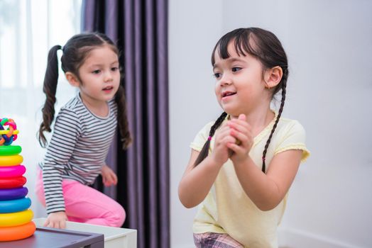 Two little girls playing small toy balls in home together. Education and Happiness lifestyle concept. Funny learning and Children development theme. Smile faces