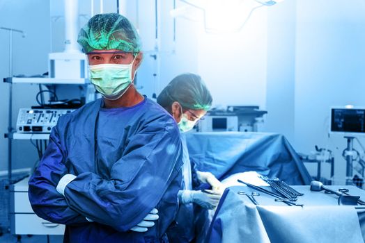Professional doctor and nurse in operation room. Portrait and Healthcare concept. Teamwork and success concept.Working people in hospital and Plastic surgery for beauty theme. Blue filter background.