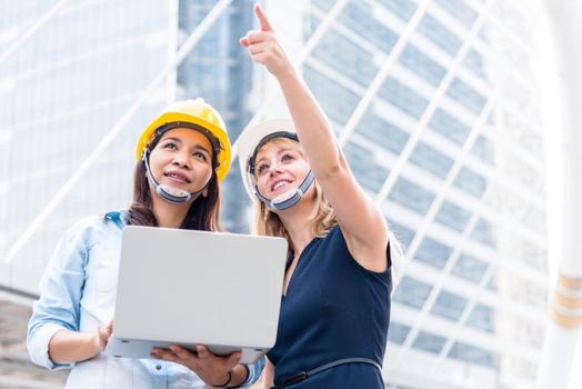 Two women engineering surveying for startup and launching new project. Building and construction concept. Business and happiness of cooperation concept. Civil engineer theme. City and urban theme