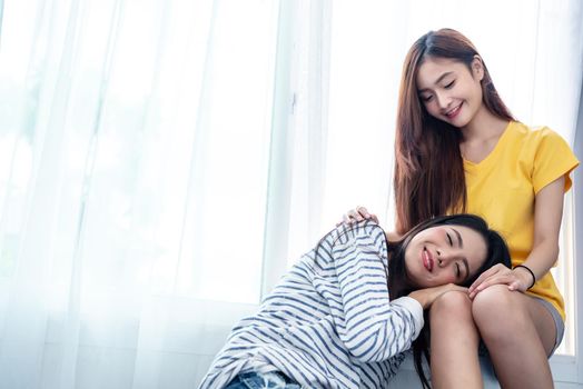 Asian couple take care together near white window with soft sunshine in happiness moment together. People and Lifestyles concept. Lesbian and friendships theme. LGBT theme.