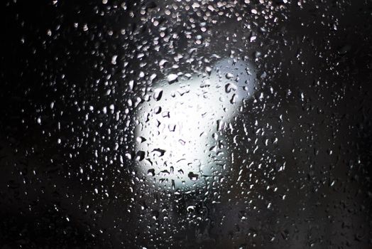 Rain drop on windshield. Weather forecast and Nature. Car and Transport theme. Rainy and Storm theme.
