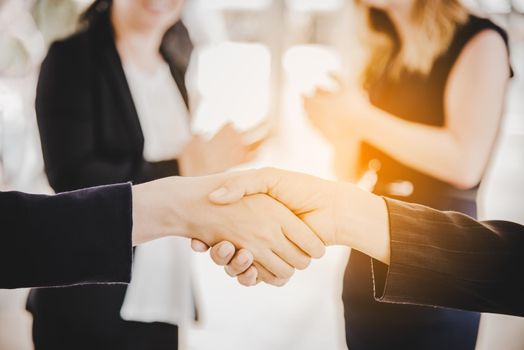 Business people shaking hands after finish reach agreement for startup new project. Negotiating and Happy working concept. Handshake gesturing connection deal concept. People and teamwork theme