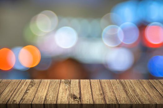 Empty table with colorful bokeh. 3D illustration. City light concept