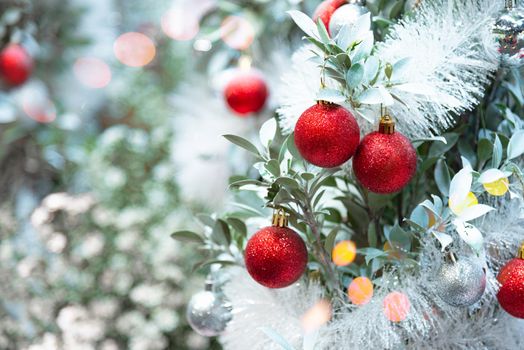 Closeup of decorate ornament on Christmas tree with bokeh defocused light background. Holiday celebration and vacation. Merry xmas and happy new year season concept.
