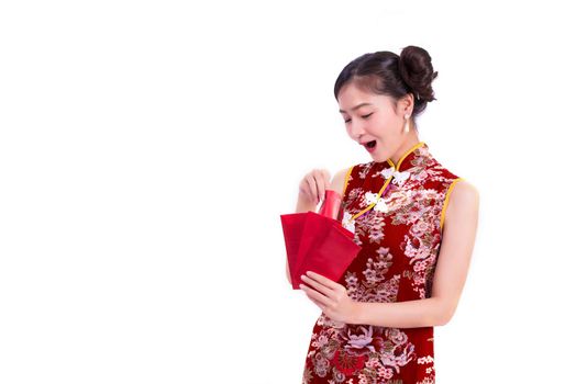 Young Asian beauty woman wearing cheongsam and holding packet of moneys and surprising gesture in Chinese new year festival event on isolated white background. Qipao dress wearing. Lifestyle concept