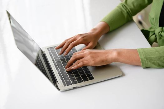 Closeup of woman hand working at home office and typing on keyboard. Business and technology theme. People lifestyles and Office occupation concept. Accounting and Computer. Social distancing theme