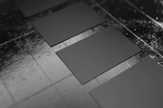 Black horizontal business card paper mockup template with blank space cover for company logo or personal identity row arranging on concrete floor background. Selective focus. 3D illustration render