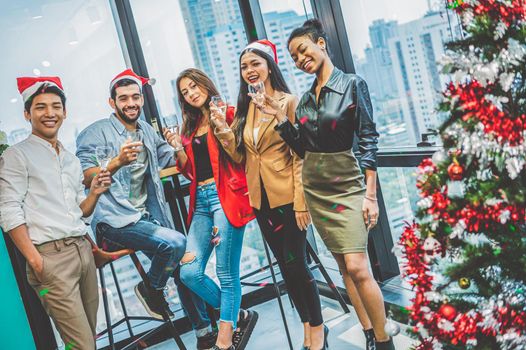 Group of business diversity colleague teamwork celebaring for New Year party in modern urban office background. Friends having enjoy party with alcoholivd drink together. Multi ethics people lifestyle