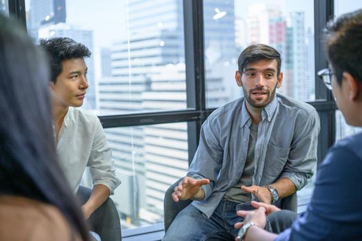 Psychotherapist inquiring about symptoms occurring within mind from patients with mental health problems in hospital. Group psychotherapy for support and helping worried man to change negative mindset