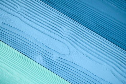 Top diagonal view of blue wooden textured background backdrop. Abstract wallpaper pastel blue ocean color