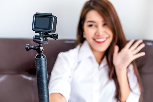 Closeup of action camera with professional digital content creator blogger recording video blog presentation clip for upload to website as coach and tutor to making for popular vlog and master class