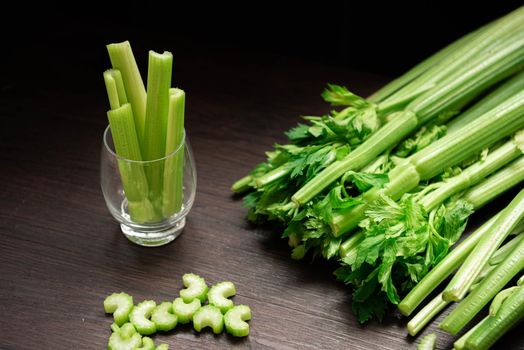 Bunch of fresh celery stalk on wooden table with leaves prepared for making juice. Food and ingredients  of healthy vegetable. Freshness herbal and low calories for dieting with plenty of vitamin