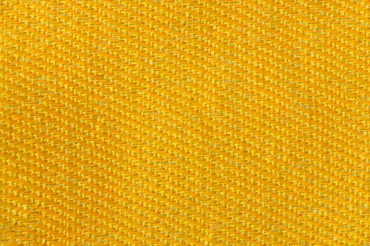 Yellow gold canvas fabric texture background. Textile and decoration concept. Wallpaper and interior design