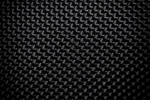 Black fabric canvas silk texture background. Abstract closeup detail of textile material wallpaper.