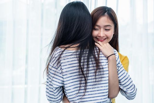 Two Asian women embracing together in bedroom. Couple people and Beauty concept. Happy lifestyles and home sweet home theme. Homosexual and Love scene of females. LGBT pride and Lesbian couples theme.