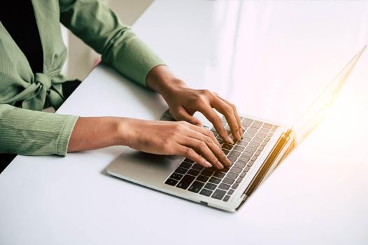 Closeup of woman hand working at home office and typing on keyboard. Business and technology theme. People lifestyles and Office occupation concept. Accounting and Computer freelance programming theme
