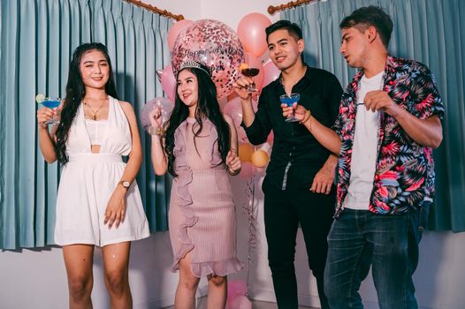 Happy friends dancing and having fun in New year party at night club. Event celebration and anniversary concept. People lifestyles and friendship.