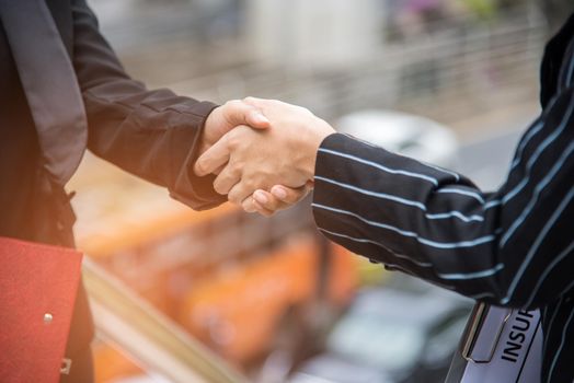 Businesswomen handshake at outdoor. Successful of businesswomen after sign contact and good dealing. Business partnerships meeting and coworking concept. Appointment and employment concept idea