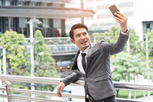 Business man selfie himself by smart phone camera. Business and Technology concept