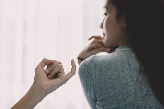 Beauty Asian woman was reconciled by boyfriend after argument in bedroom background. Depressed and bright tone feeling. People and lifestyles concept. Making friendly again theme.