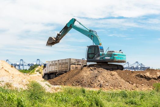 Digger car load and transfer soil to truck on the hill, Technology machine and Transport concept