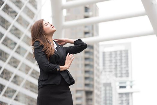 Business woman look up and flick her hair at outdoor. Business and Beauty concept