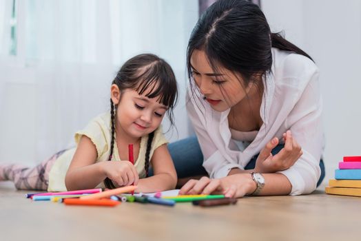 Mom teaching her daughter to drawing in art class. Back to school and Education concept. Children and kids theme. Home sweet home theme.