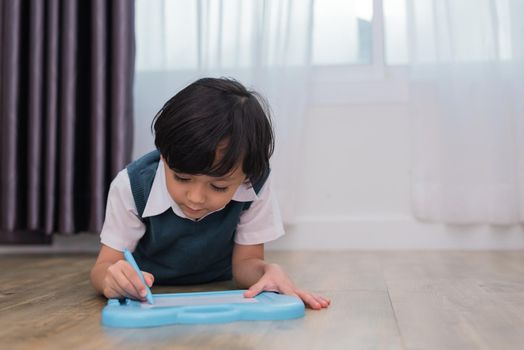 Little boy drawing cartoon in chalkboard. Education and Back to school concept. Kids development theme.