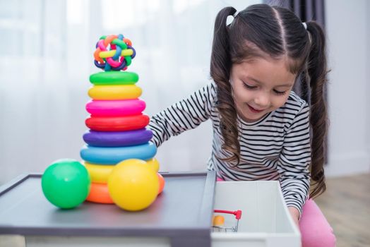 Little girls playing small toy hoops in home. Education and Happiness lifestyle concept. Funny learning and Children development theme. Smile faces