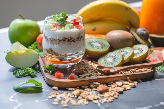 Closeup nutrition yogurt with many fruits on table. Food cuisine and drinks concept. Organic dessert theme.