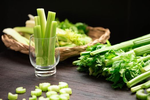Bunch of fresh celery stalk on wooden table with leaves prepared for making juice. Food and ingredients  of healthy vegetable. Freshness herbal and low calories for dieting with plenty of vitamin