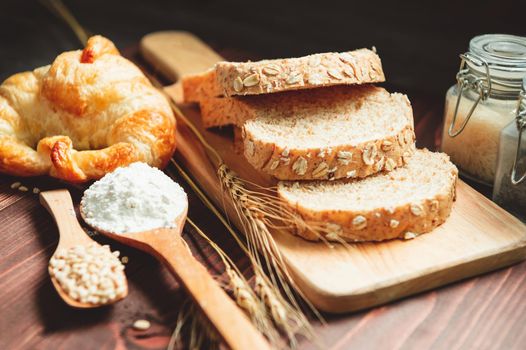 Different kinds of bread with nutrition whole grains on wooden background. Food and bakery in kitchen concept. Delicious breakfast gouemet and meal. Carbohydrate organic food cuisine homemade