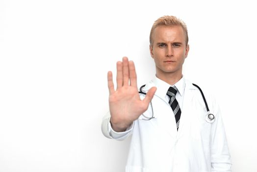 Doctor with stethoscope show off "stop" or "not allowed" sign by his hand on the white background. Medical and Healthcare concept. Hospital theme