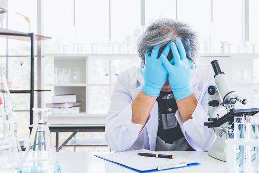 Exhausted scientist sleeping in laboratory. People lifestyles and occupation concept. Science and experiment in lab theme.
