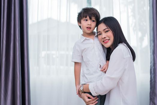 Beauty Asian woman hug and carry her son. Happy family and Home sweet home concept. Love and Lifestyle theme.
