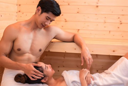 Asian couples are passionate in sauna room. People and Lifestyles concept. Vacation and Relaxation theme.