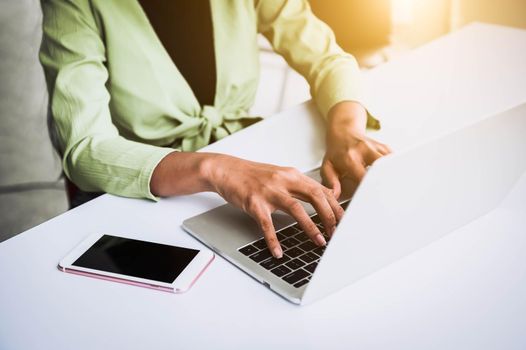 Closeup of woman hand working at home office and typing on keyboard. Business and technology theme. People lifestyles and Office occupation concept. Accounting and Computer freelance programming theme