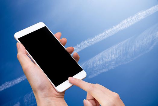 Woman hold smart phone and touch button by hand with blank screen for advertisement, Blue Sky and abstract background ,Technology and Nature concept