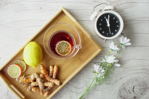 Top view of ginger tea on wooden background..