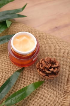 herbal cream cosmetic in a container on table