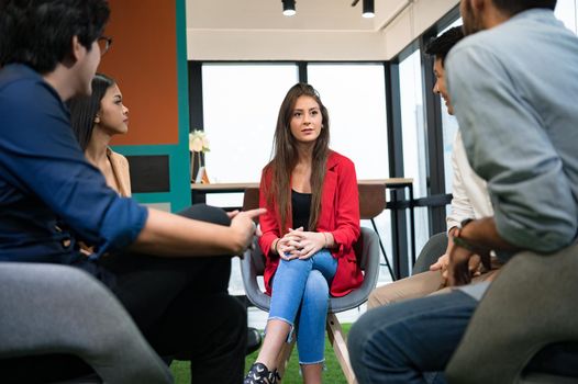 Psychotherapist inquiring about symptoms occurring within mind from patients with mental health problems in hospital. Group psychotherapy for support and helping worried man to change negative mindset