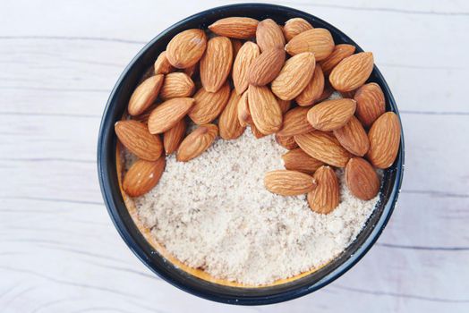 almond powder and almond in a jar on table