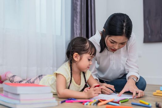 Mom teaching her daughter to drawing in art class. Back to school and Education concept. Children and kids theme. Home sweet home theme.