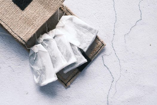 tea bag with small bag on table close up .