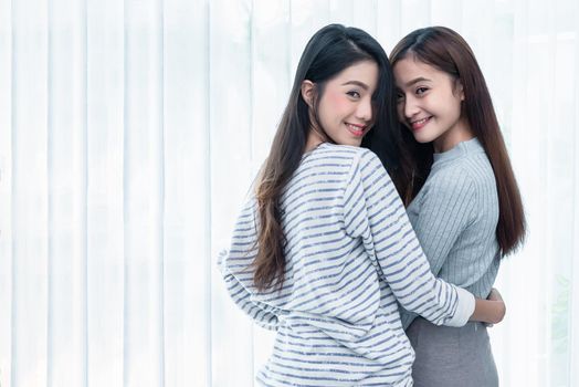 Two Asian Lesbian women looking together in bedroom. Couple people and Beauty concept. Happy lifestyles and home sweet home theme. Embracing of homosexual. Love scene making of female