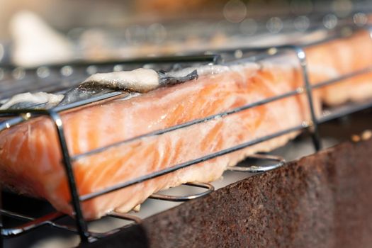 Cooking salmon steak close-up on an outdoor barbecue grill. Selective focus