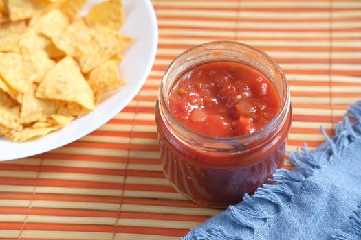 a bowl of chips and salsa on table