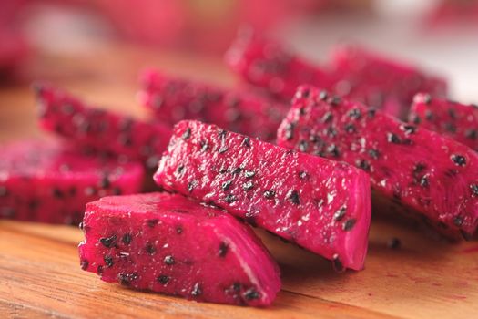 slice of dragon fruit on a chopping board.,