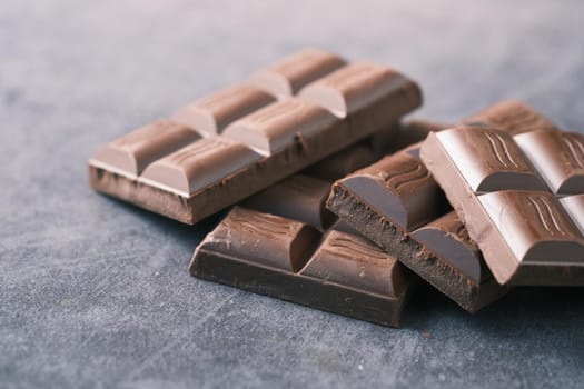 dark chocolate on a plate on pink background .